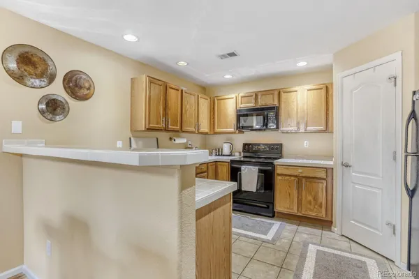a kitchen with stainless steel appliances granite countertop a stove top oven sink and cabinets