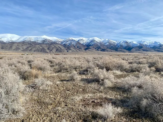 a view of mountain with sunset in background