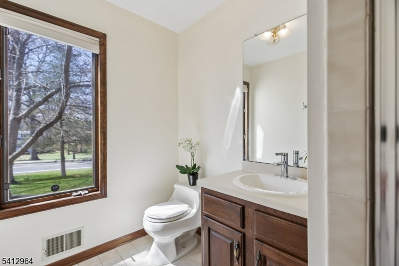 34 Knollcroft Road Bernards, NJ 07920 - Photo 18 of 34 a bathroom with a granite countertop sink toilet and large mirror