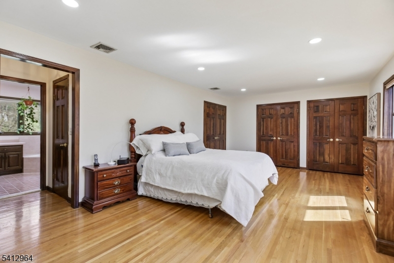 34 Knollcroft Road Bernards, NJ 07920 - Photo 19 of 34 a spacious bedroom with a bed and a dresser