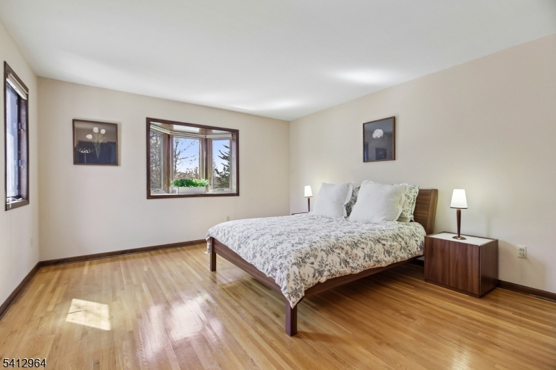 34 Knollcroft Road Bernards, NJ 07920 - Photo 23 of 34 a bedroom with a bed and a night stand