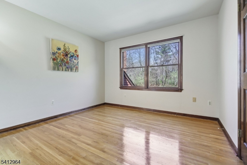 34 Knollcroft Road Bernards, NJ 07920 - Photo 26 of 34 an empty room with wooden floor and windows
