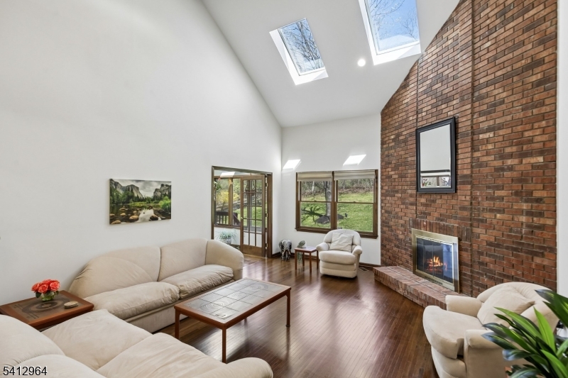 34 Knollcroft Road Bernards, NJ 07920 - Photo 7 of 34 a living room with furniture a fireplace and a large window