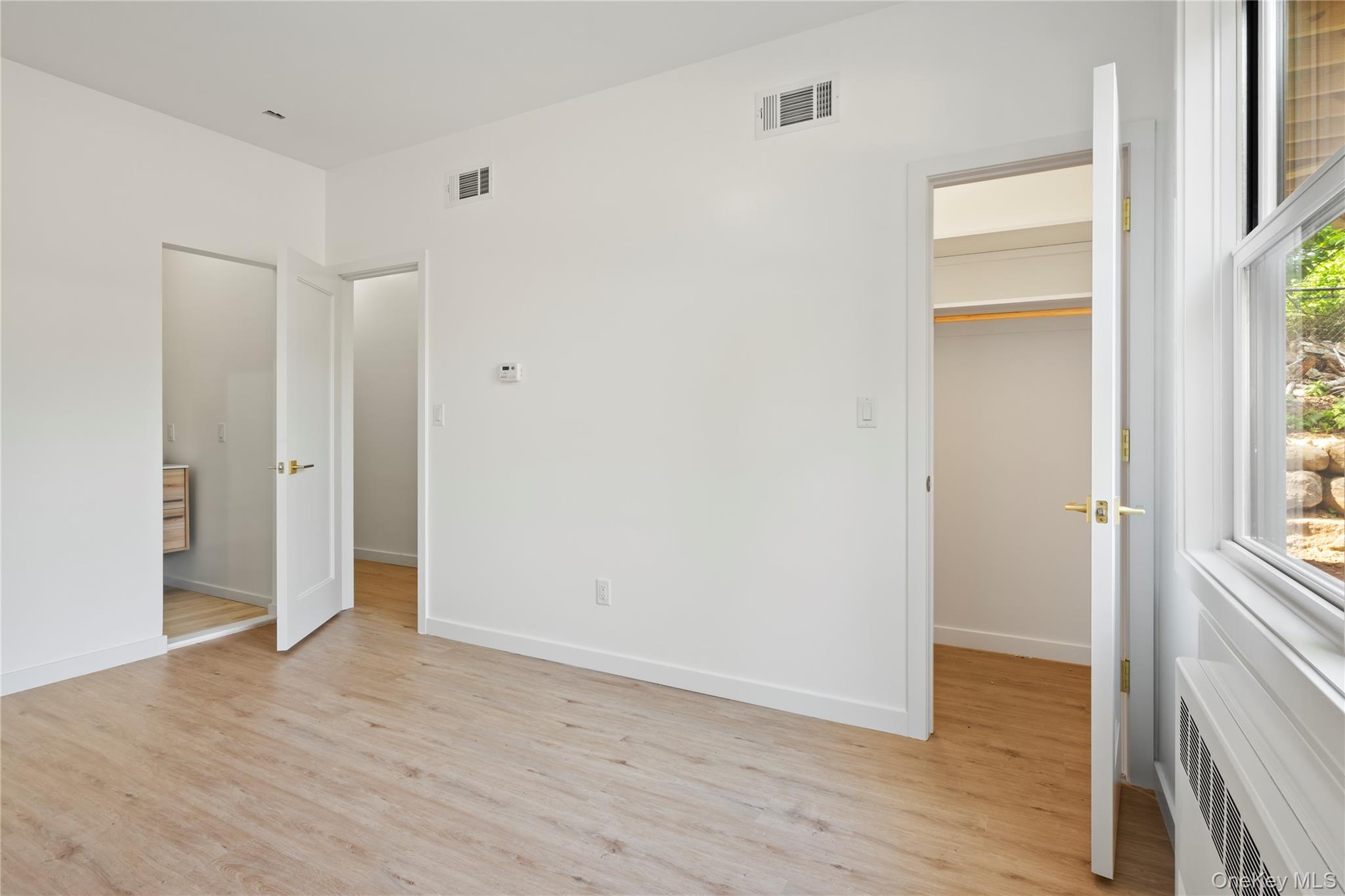 130 Union Road, Unit 201 Spring Valley, NY 10977 - Photo 42 of 47 a view of an empty room with wooden floor and a window