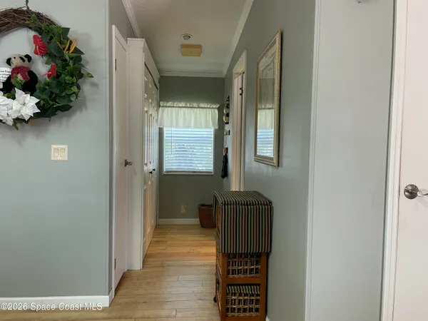 a living room with furniture a rug and kitchen view