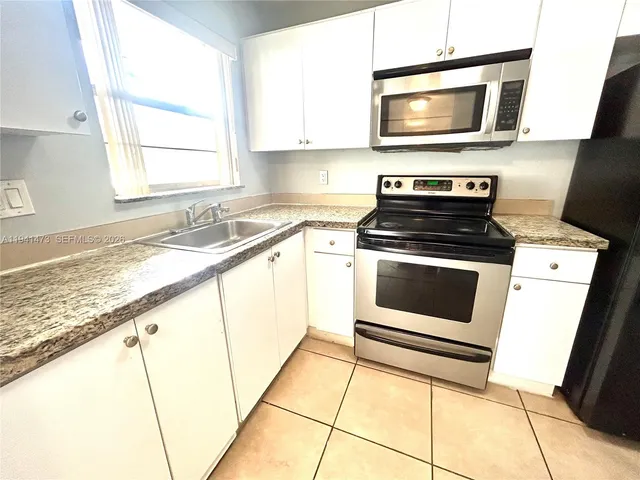 a kitchen with a stove microwave and sink