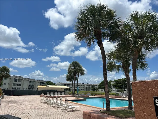 a view of a yard with palm trees