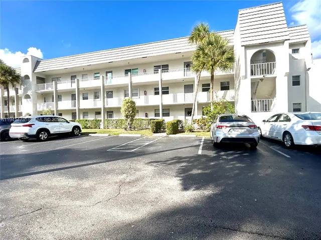 a building with cars parked in front of a house