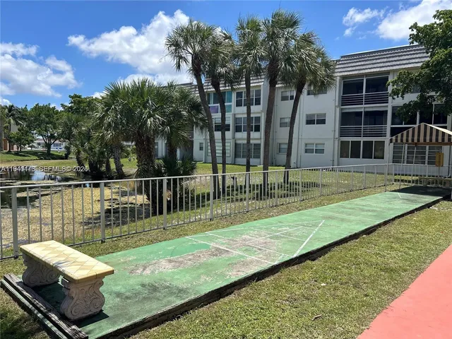 a view of a swimming pool with a patio and a yard