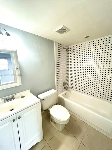 a bathroom with a toilet a sink and bathtub