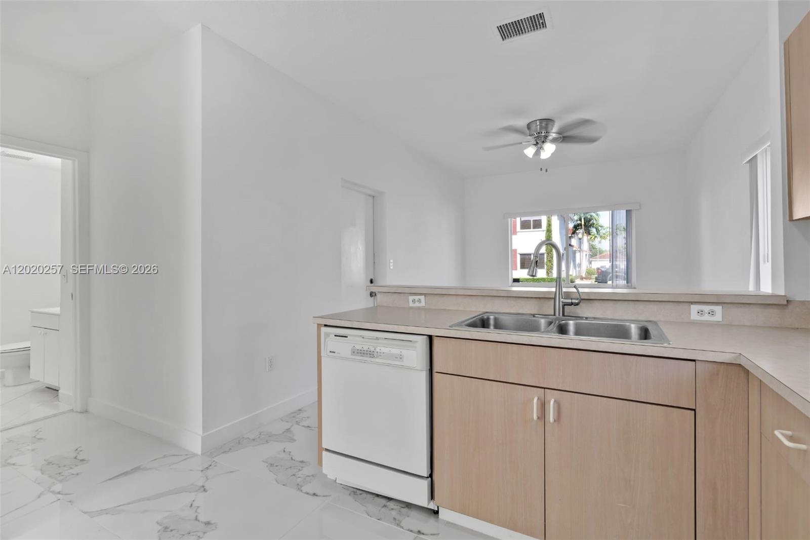 10245 Southwest 154th Place, Unit 1123 Miami, FL 33196 - Photo 14 of 38 a kitchen with a sink and a window