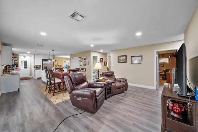a living room with furniture flat screen tv and fireplace