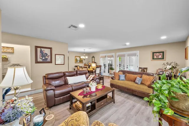 a living room with furniture a rug and a lamp