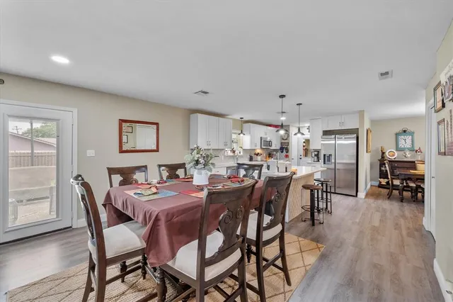 a dining room with furniture and wooden floor