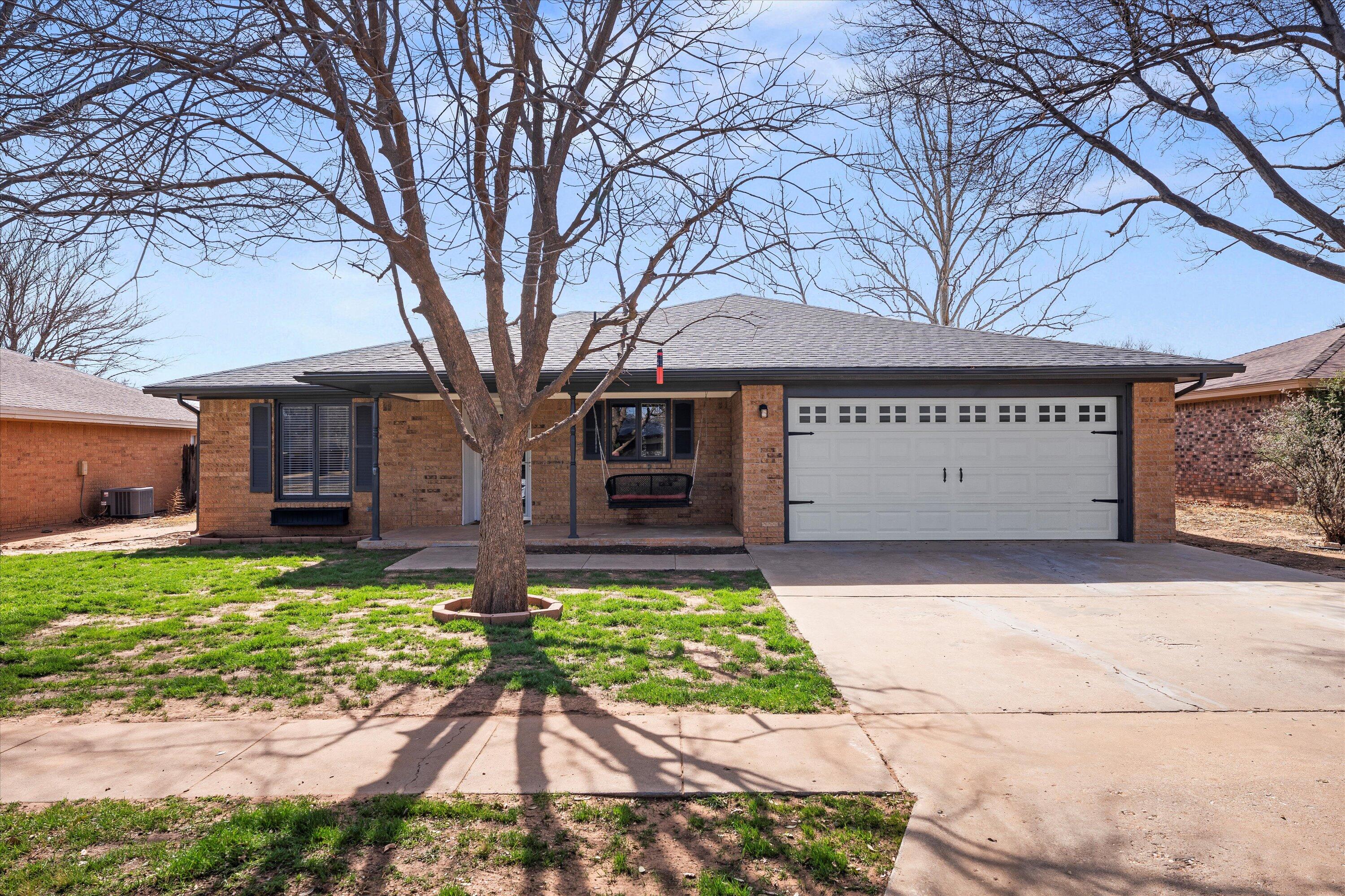 5223 91st Street Lubbock, TX 79424 - Photo 1 of 29 a front view of a house with garden