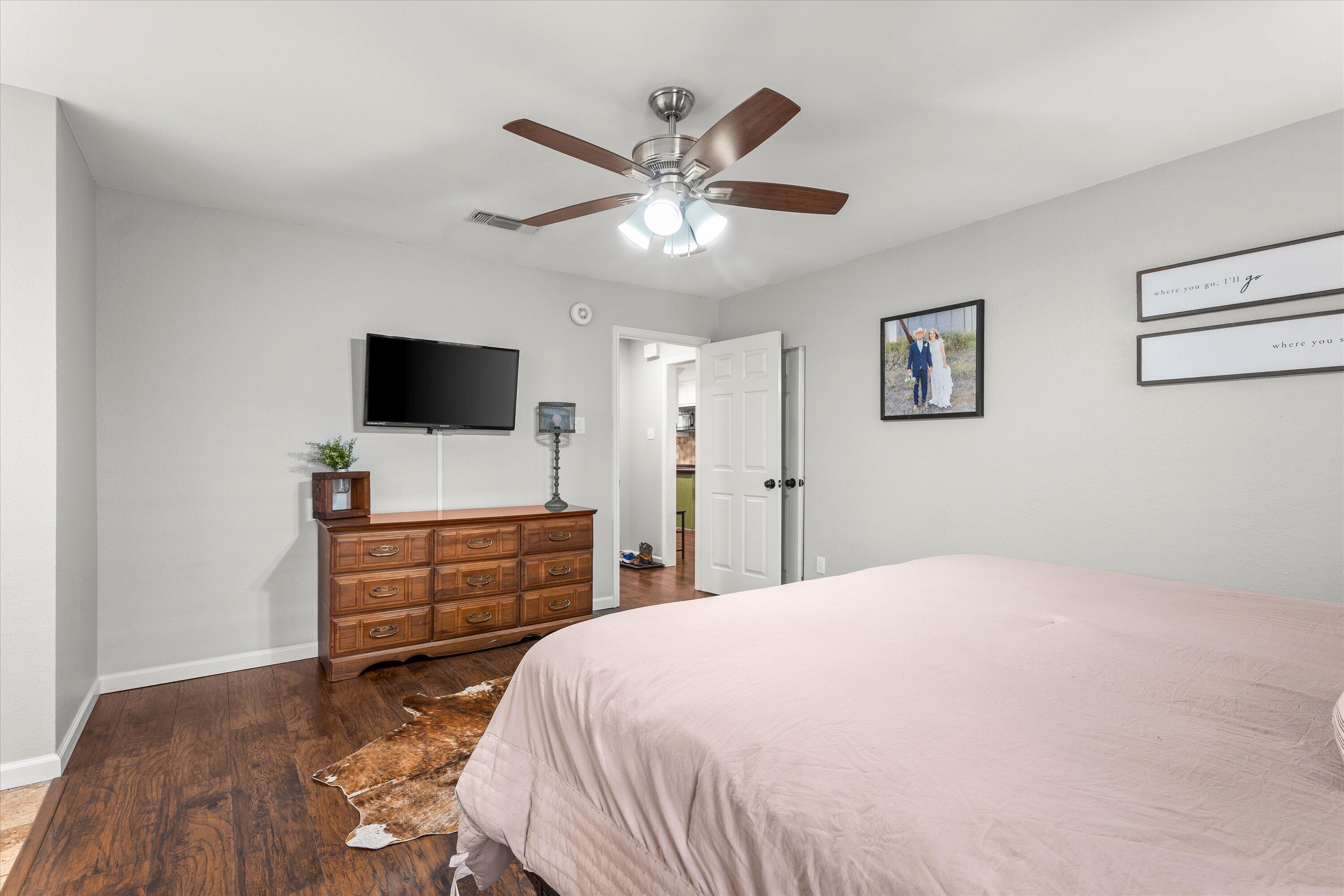 5223 91st Street Lubbock, TX 79424 - Photo 14 of 29 a bedroom with a bed and a flat screen tv
