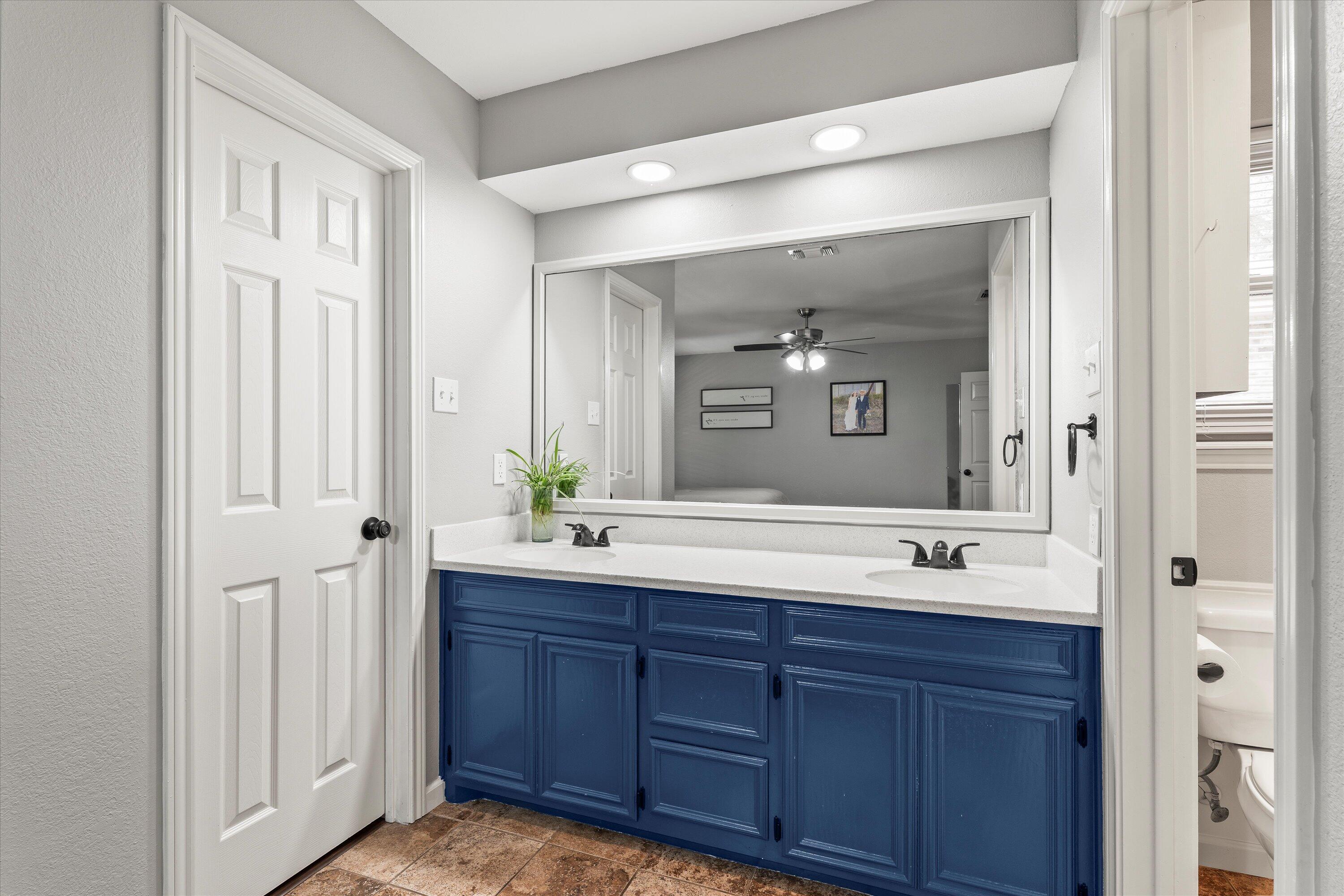 5223 91st Street Lubbock, TX 79424 - Photo 15 of 29 a bathroom with a granite countertop sink mirror and double
