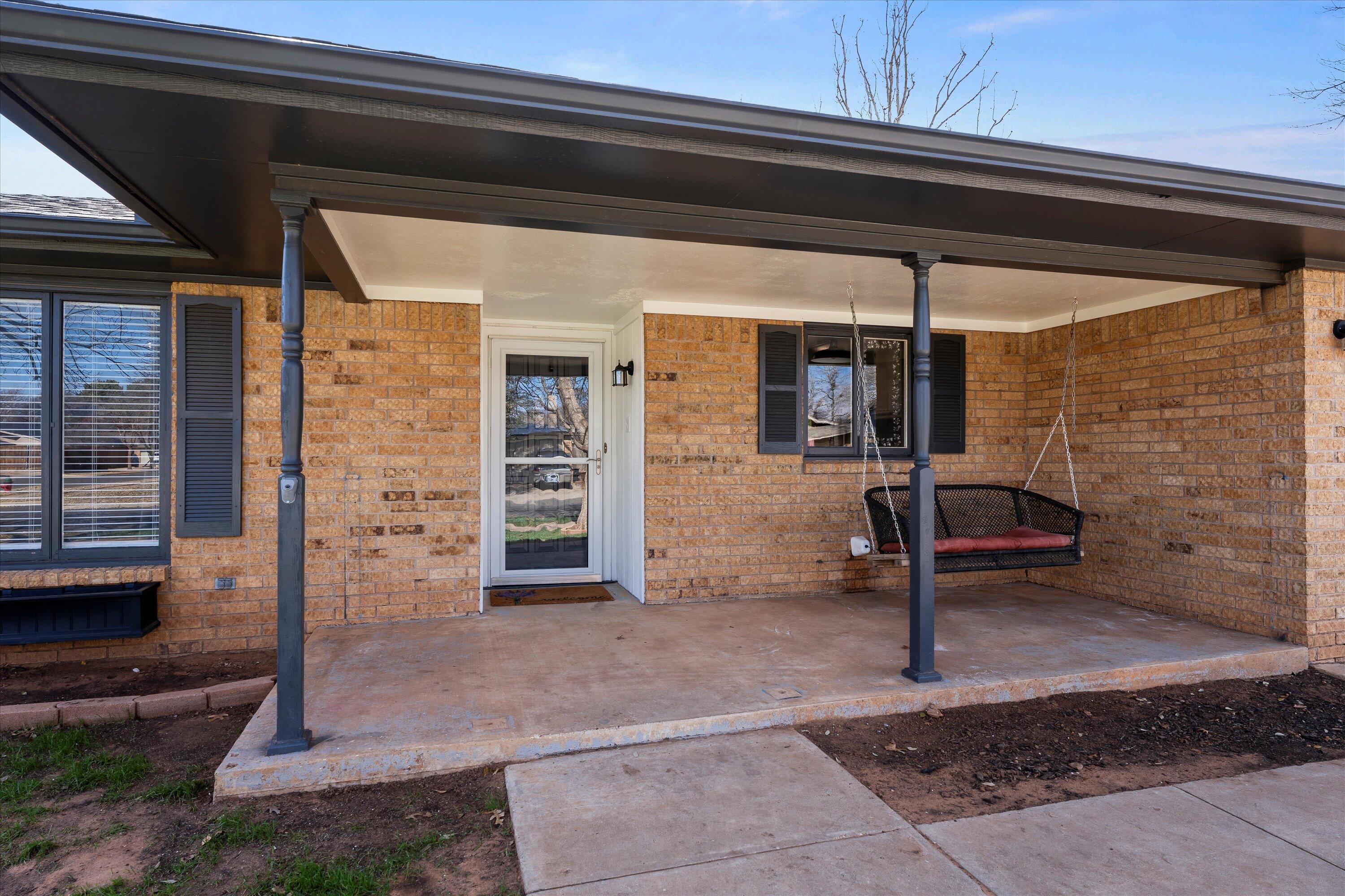 5223 91st Street Lubbock, TX 79424 - Photo 17 of 29 a view of a porch with a table and chairs
