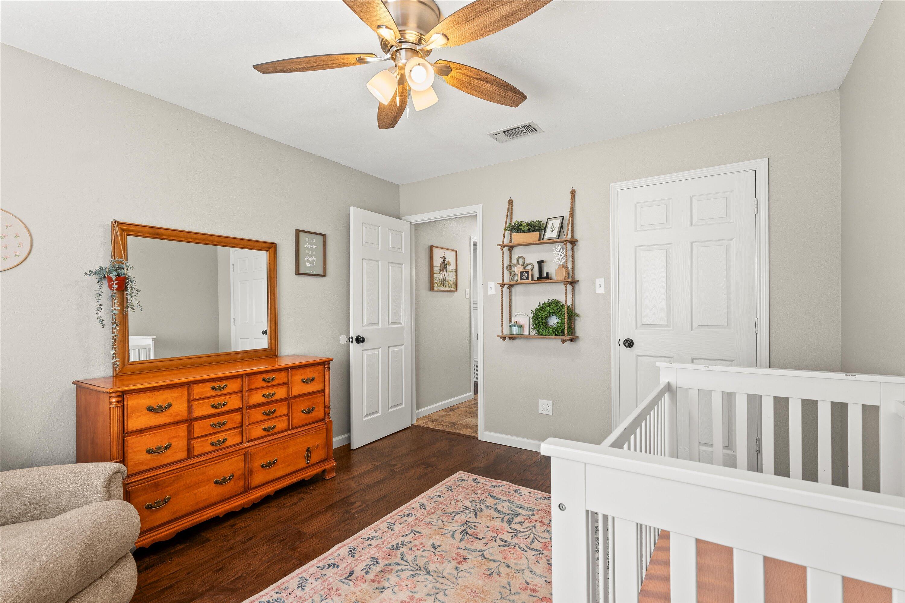 5223 91st Street Lubbock, TX 79424 - Photo 19 of 29 a living room with furniture and a baby crib