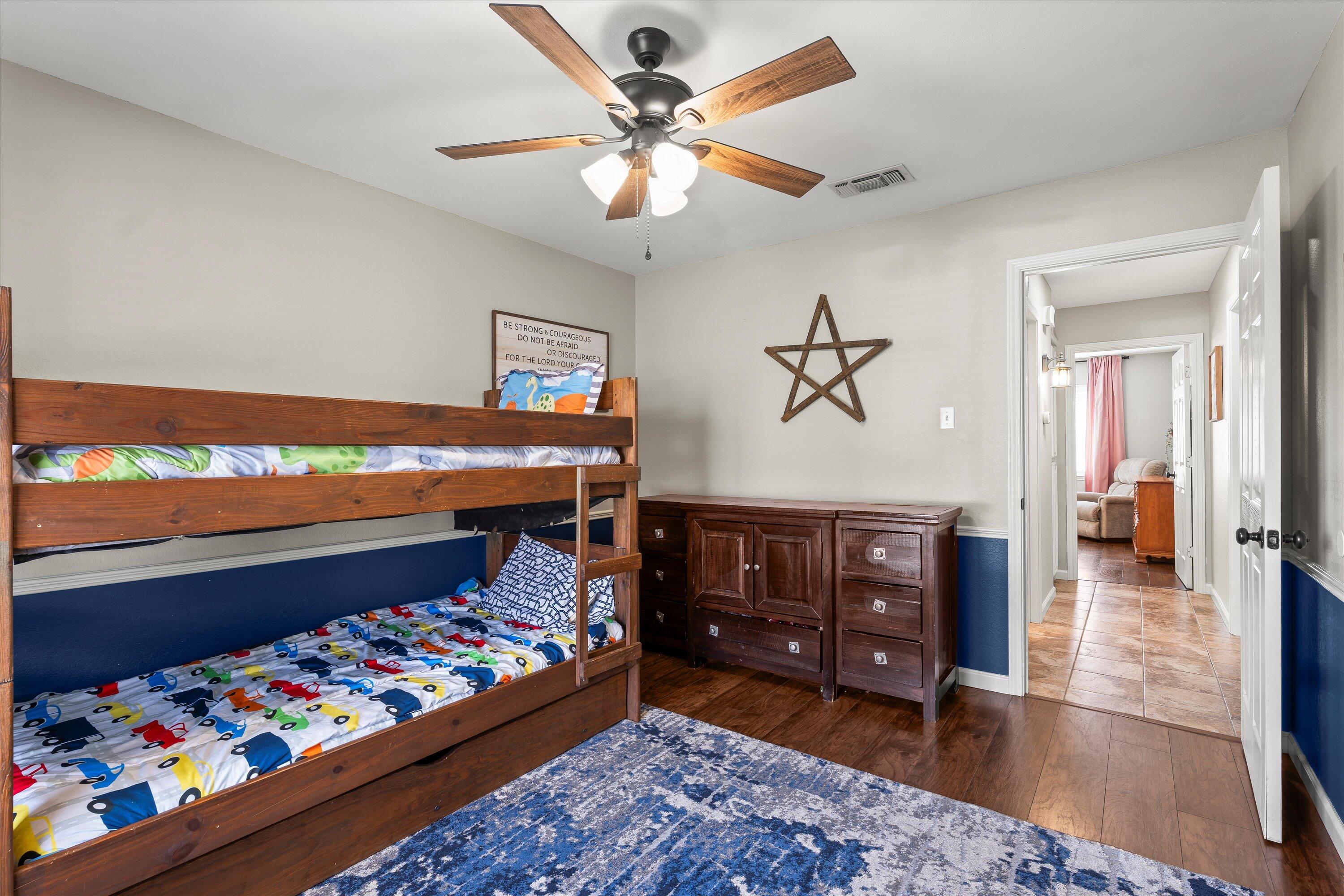 5223 91st Street Lubbock, TX 79424 - Photo 21 of 29 a bed room with a bed and a dresser