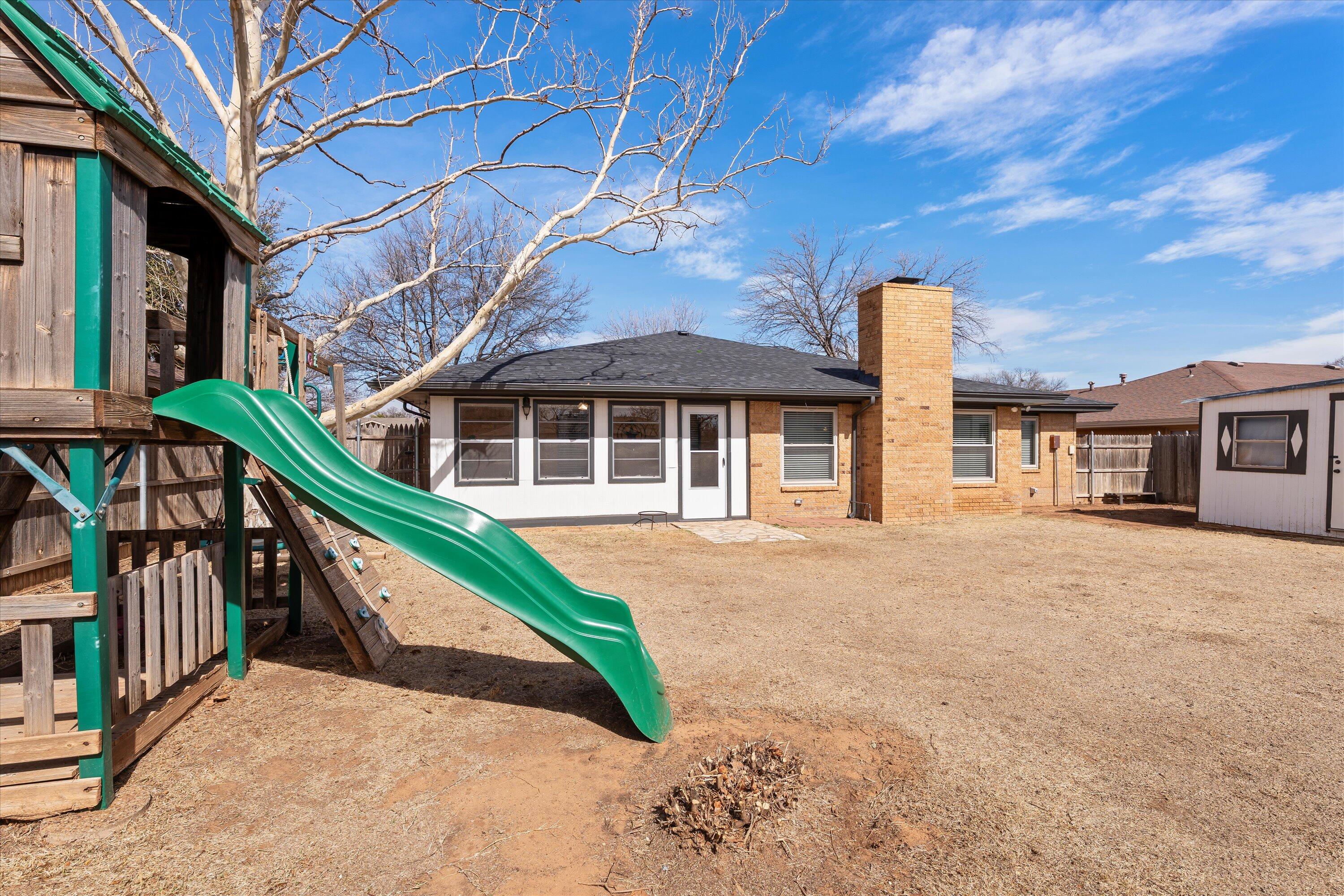 5223 91st Street Lubbock, TX 79424 - Photo 25 of 29 a front view of a house with a yard