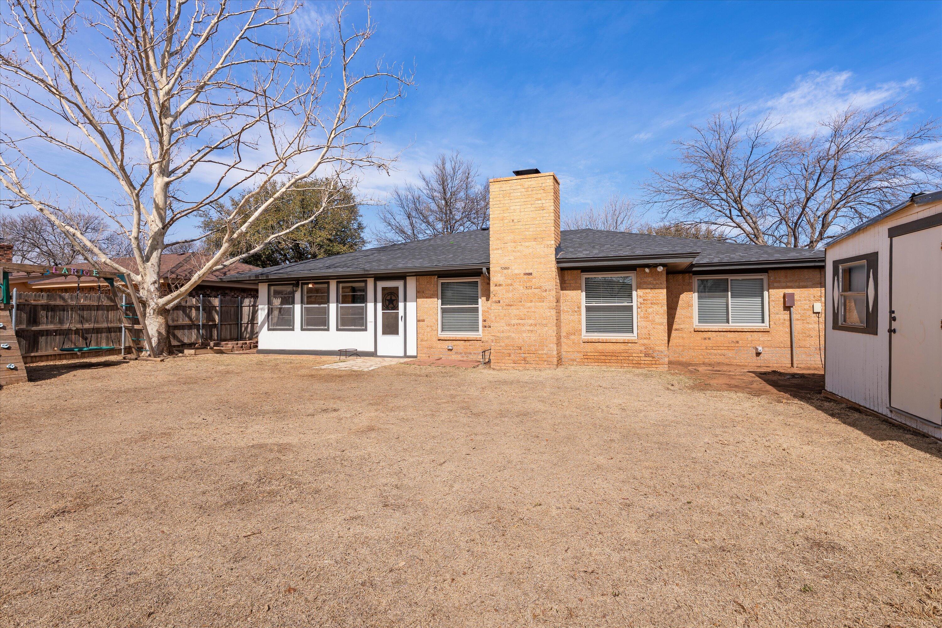 5223 91st Street Lubbock, TX 79424 - Photo 26 of 29 a front view of a house with a garden