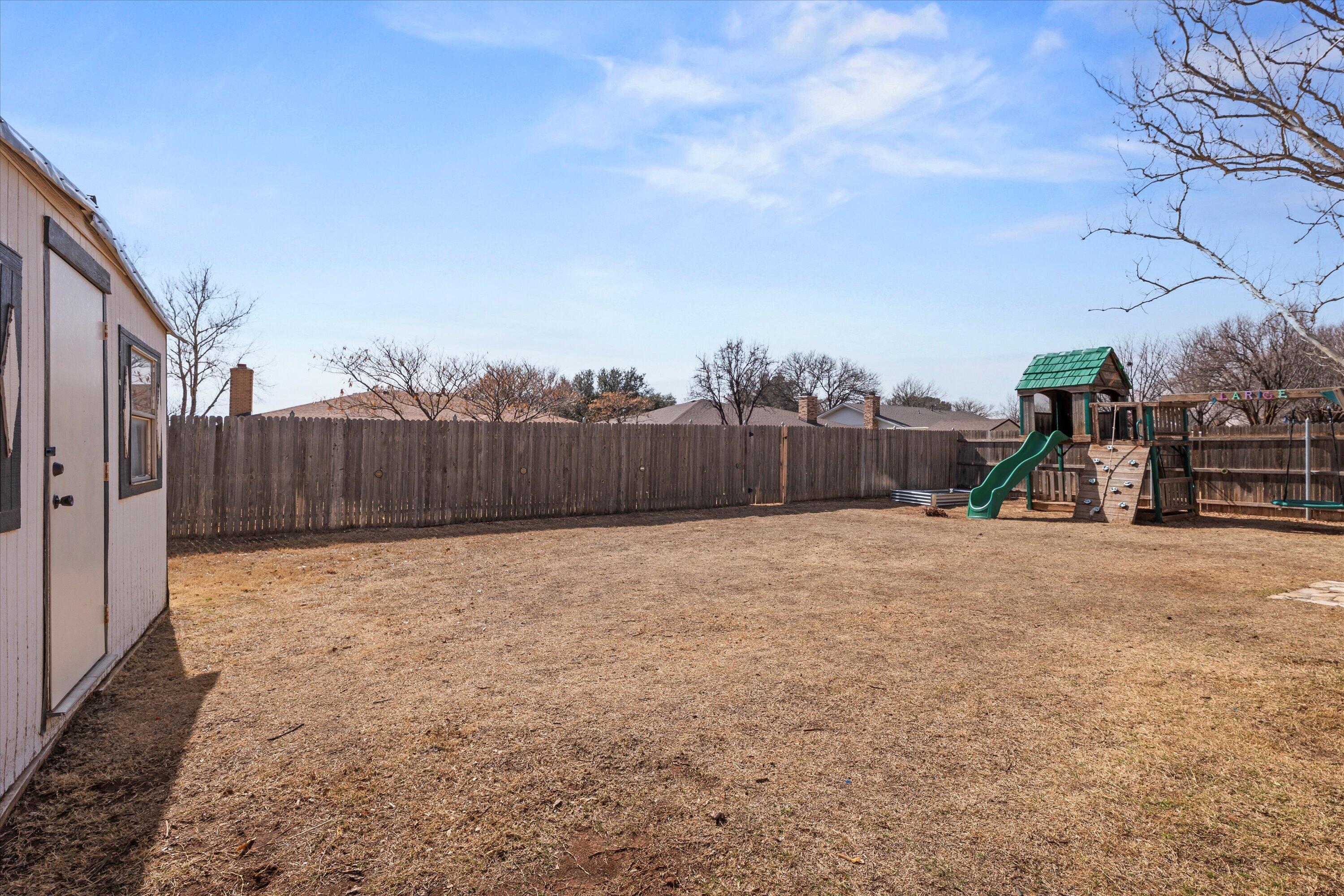 5223 91st Street Lubbock, TX 79424 - Photo 27 of 29 a backyard of a house with lots of green space