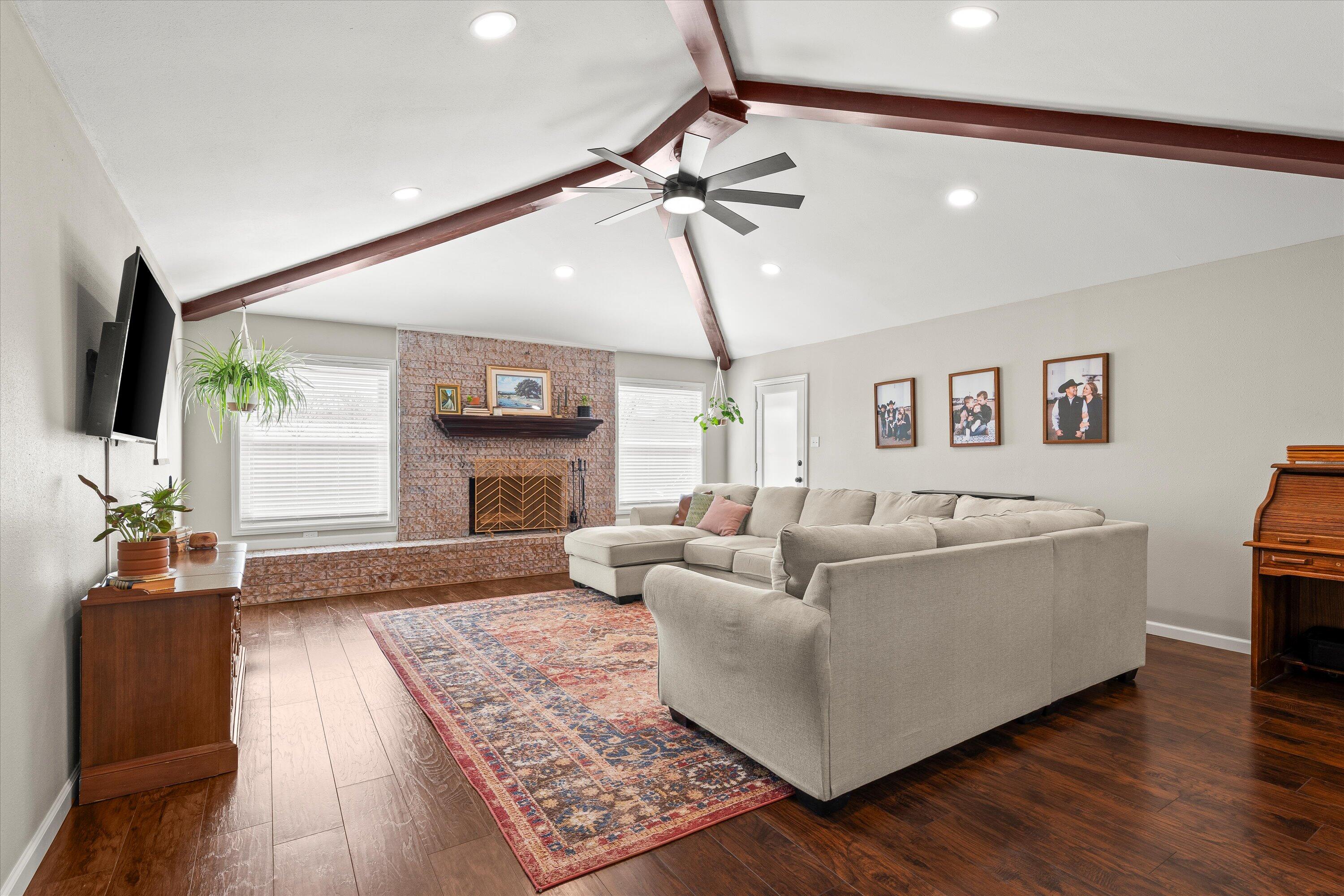 5223 91st Street Lubbock, TX 79424 - Photo 3 of 29 a living room with furniture and a flat screen tv