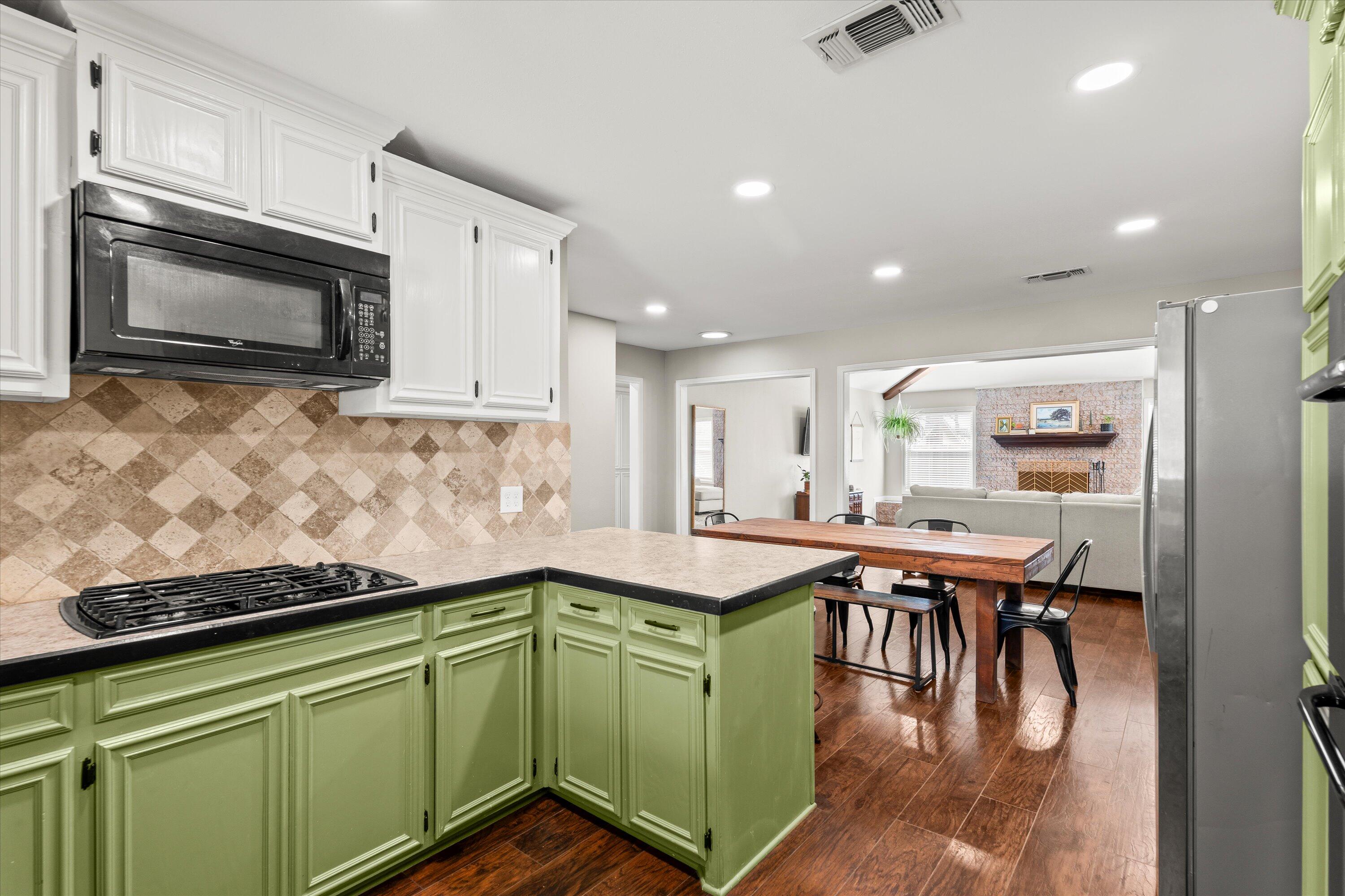 5223 91st Street Lubbock, TX 79424 - Photo 5 of 29 a kitchen with stainless steel appliances granite countertop a sink and microwave