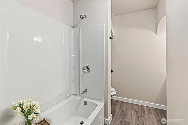 a bathroom with a tub and shower