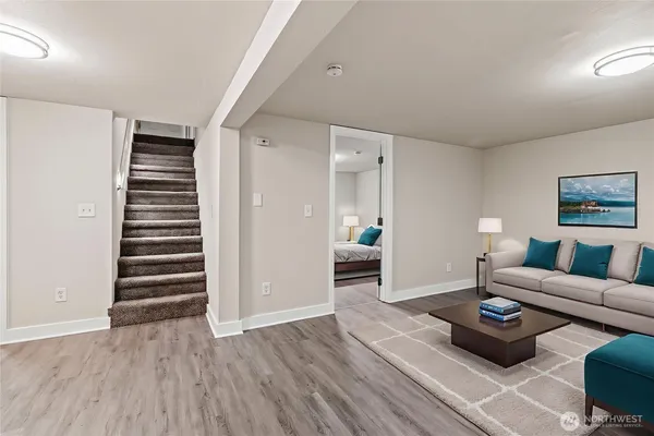 a living room with furniture and wooden floor
