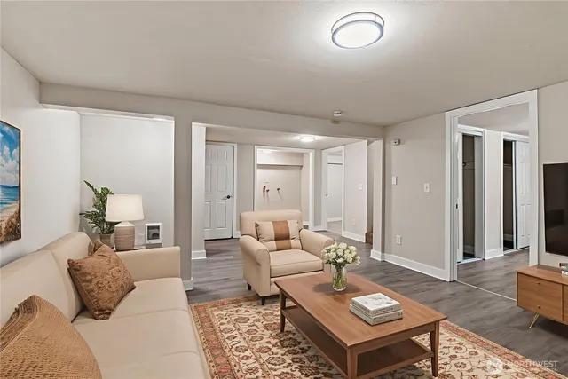 a living room with furniture a rug and a window