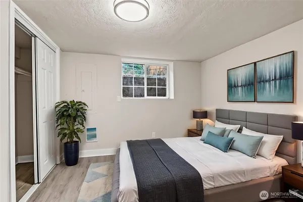 a bedroom with a bed and a potted plant