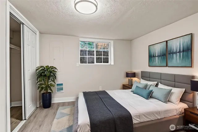 a bedroom with a bed and a potted plant