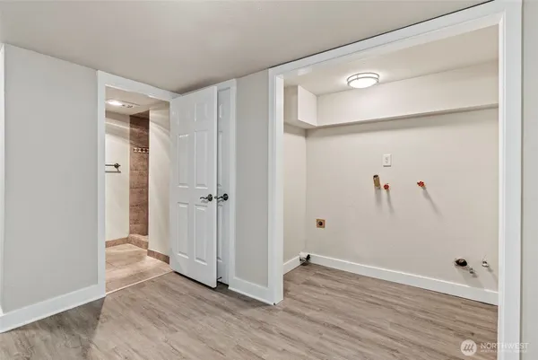 a view of a hallway with wooden floor