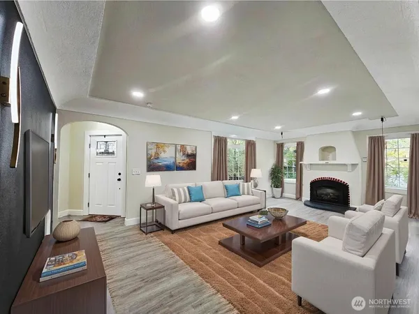 a living room with furniture large window and a fireplace