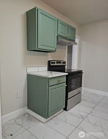 a kitchen with cabinets and steel stainless steel appliances