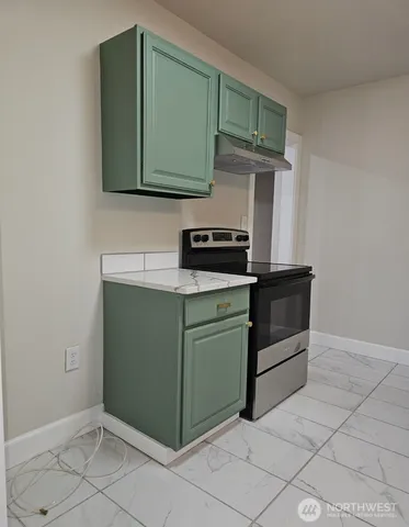 a kitchen with cabinets and steel stainless steel appliances