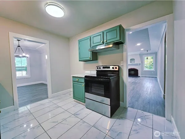 a kitchen with stainless steel appliances granite countertop a refrigerator and a stove