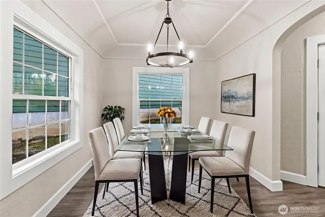 a view of a dining room with furniture wooden floor and a chandelier