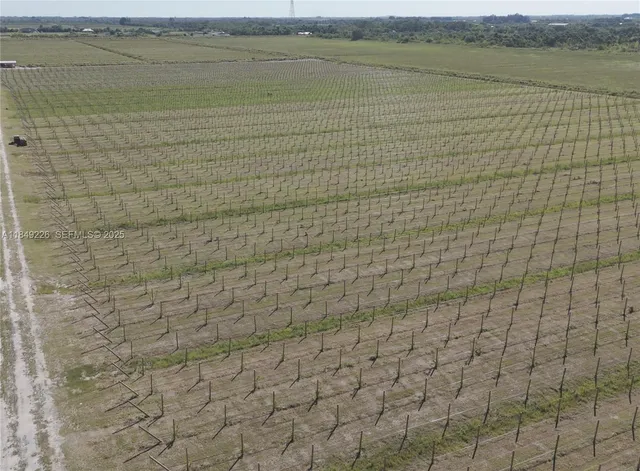 a backyard of a house with barbeque oven table and chairs