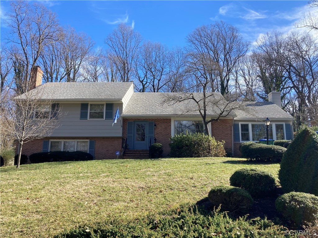 3401 Ellsworth Road Richmond, VA 23235 - Photo 1 of 39 a front view of a house with a yard and garage
