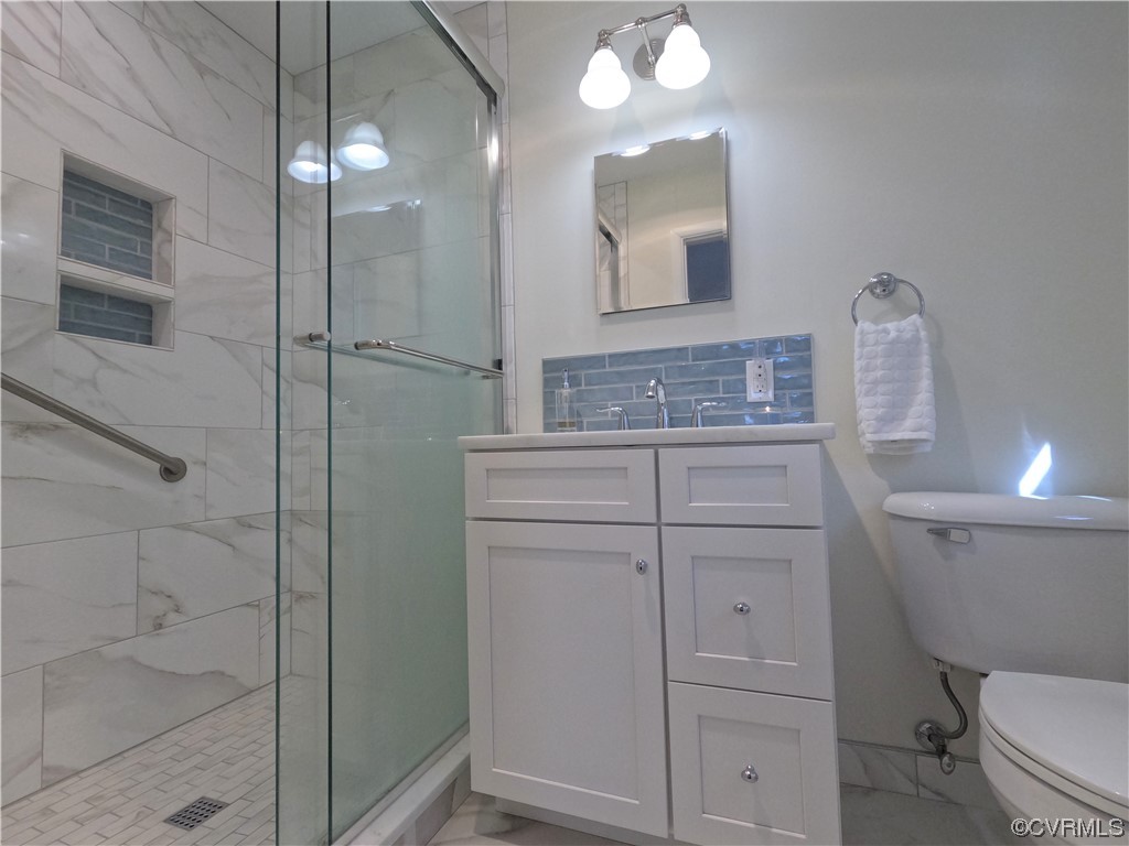3401 Ellsworth Road Richmond, VA 23235 - Photo 12 of 39 a bathroom with a toilet sink vanity and mirror