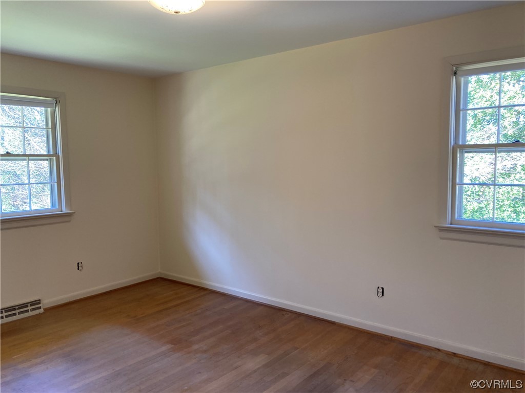3401 Ellsworth Road Richmond, VA 23235 - Photo 31 of 39 an empty room with wooden floor and windows