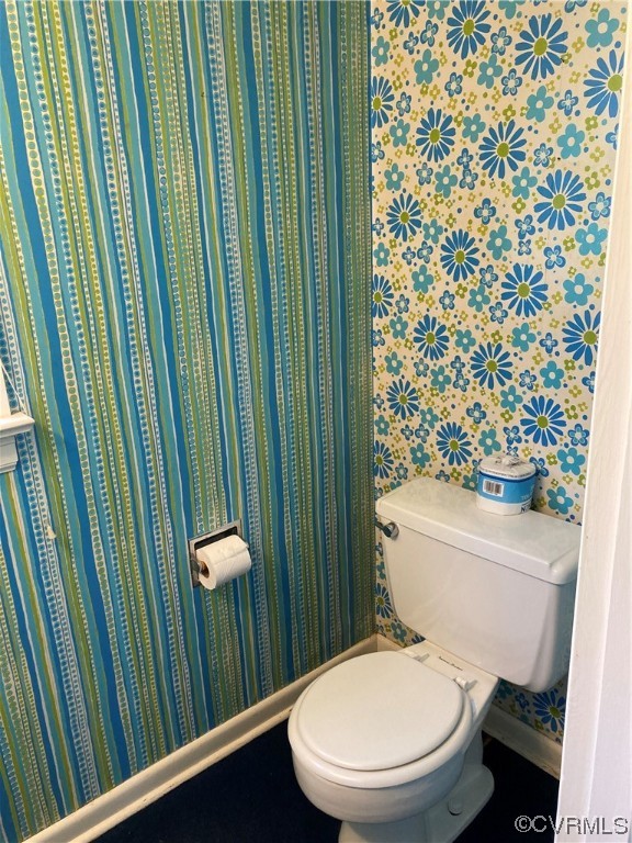 3401 Ellsworth Road Richmond, VA 23235 - Photo 36 of 39 a white toilet sitting next to a shower curtain