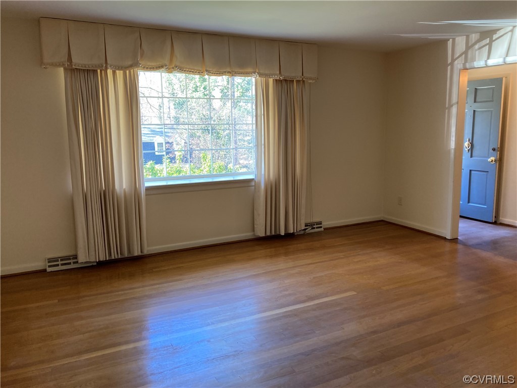 3401 Ellsworth Road Richmond, VA 23235 - Photo 4 of 39 an empty room with wooden floor and windows