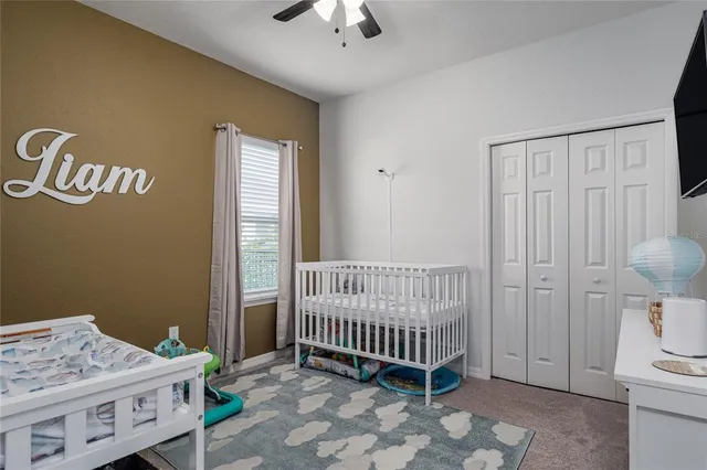 a bedroom with a bed and a window