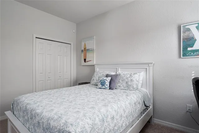 a bedroom with a bed and night stand