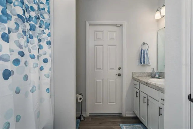 a bathroom with a granite countertop sink and a mirror