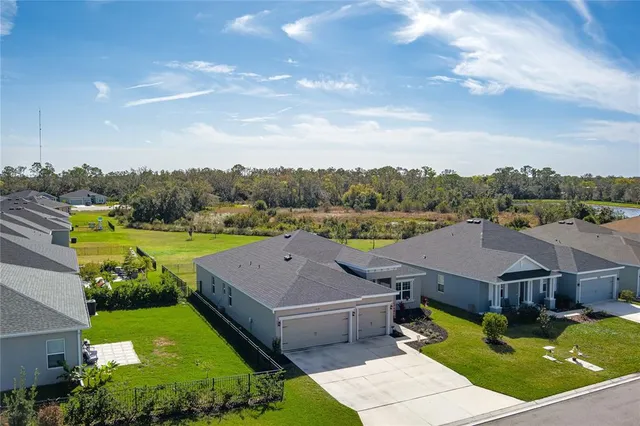 an aerial view of a house with big yard